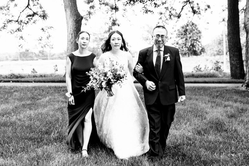 A crying father walks his daughter and wife down the aisle for the ceremony in Toledo Ohio