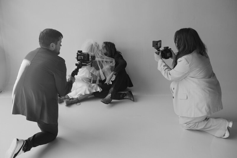 Behind-the-scenes photo of Tyler and Makenzie Films capturing a bride during a wedding shoot, specializing in Super 8 wedding videography.