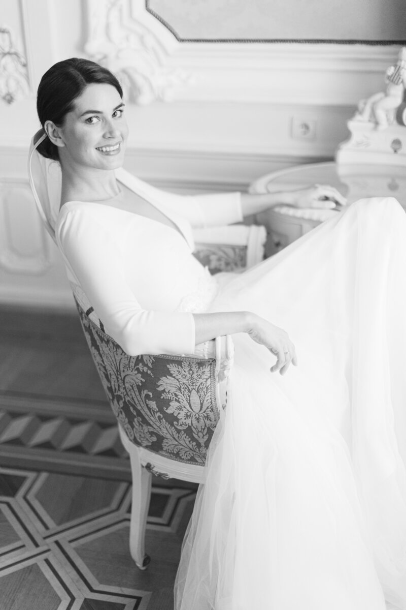 Bride sitting on a chair relaxed and smiling as ECLAT Destination Wedding is taking care of all the planning and execution