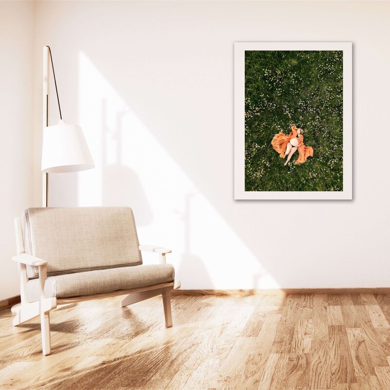 framed photo of pregnant mom laying in field of flowers