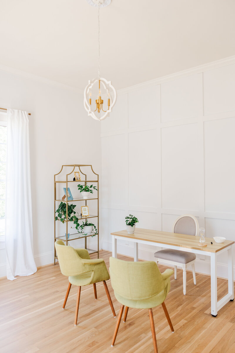 a desk, chair, and plant