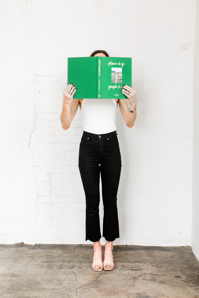 Clic Founder holding a green book - Clic