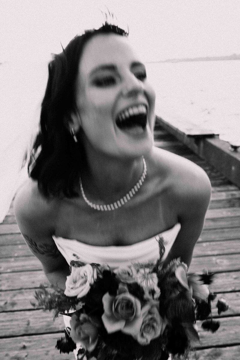 Bride laughing on the dock 