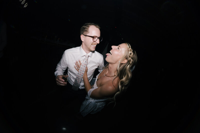 Tattooed couple sharing a candid moment during their alternative engagement studio session in Springfield, MO, photographed by Chelsea Stanford.