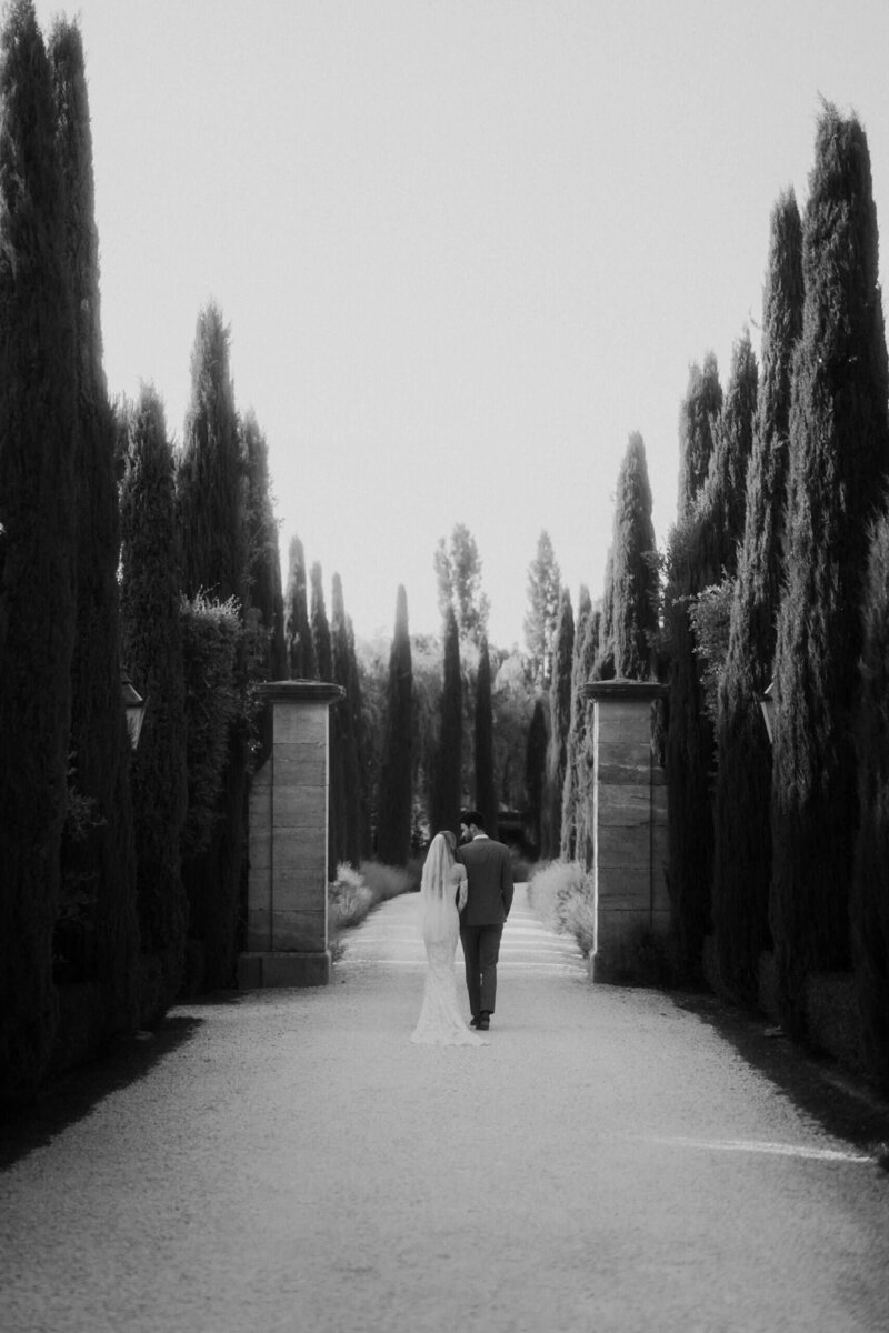 bride and groom walking in tuscany borgo santo pietro exclusive hotel 