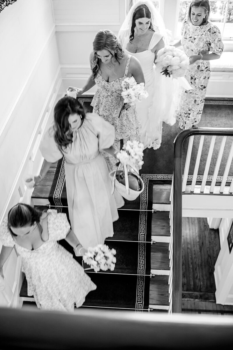 Bridesmaids walk down stairs