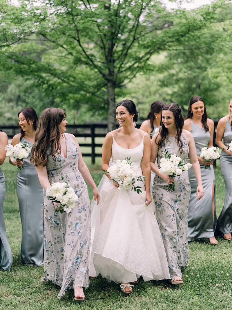 Bride and bridesmaids walk together in Georgia field