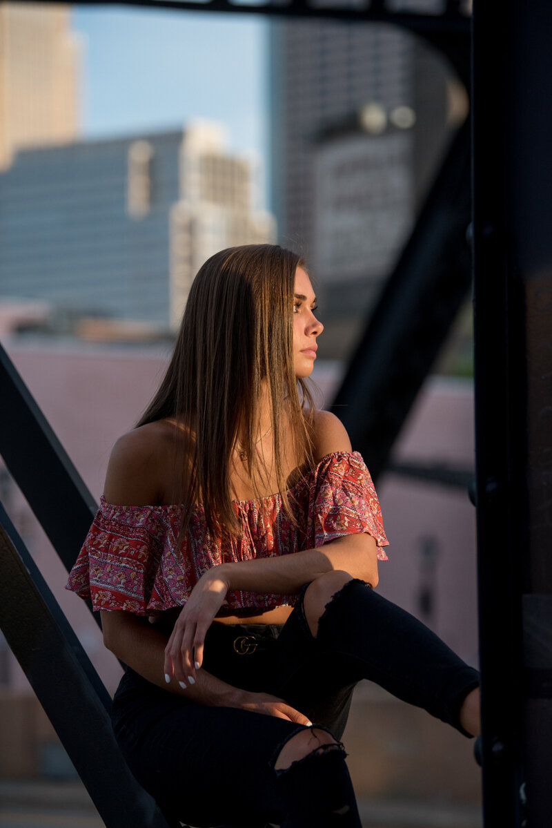 girl in crop top posing against bridge in downtown Minneapolis