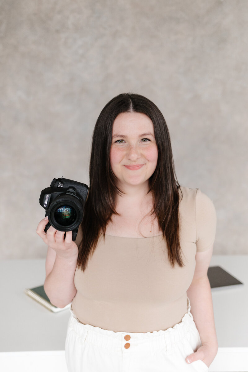 Photo of Lena holding a camera, a family and infant photographer in Camas, Vancouver and Portland