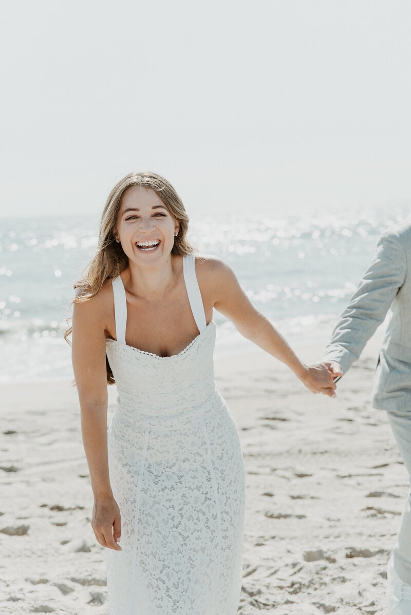 bride smiling on beach at elopement in Laguna Beach