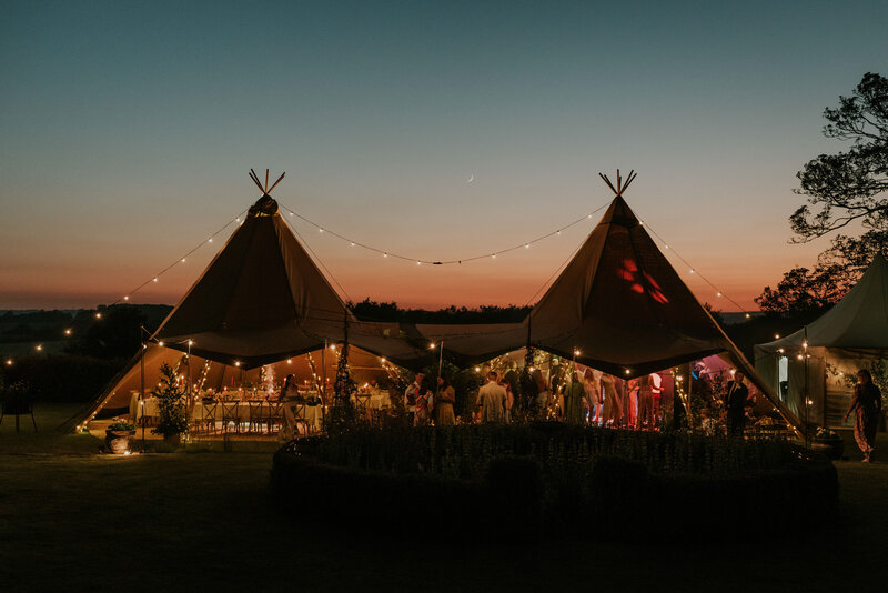 Outside wedding reception tent at dusk
