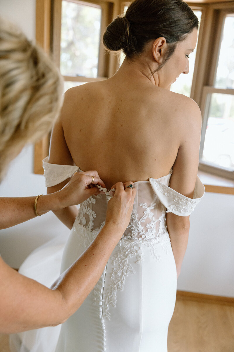 Bride getting ready after receiving a clean, bronzer-free spray tan at Boho Glow Studio in Mankato, MN.