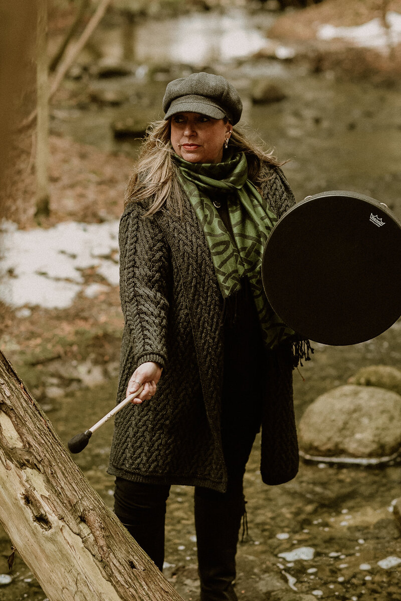 woman holding drum forest bathing