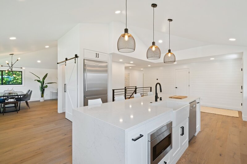 Interior kitchen with white cabinets and pendant lights