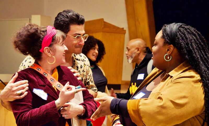 Three people talking at an event