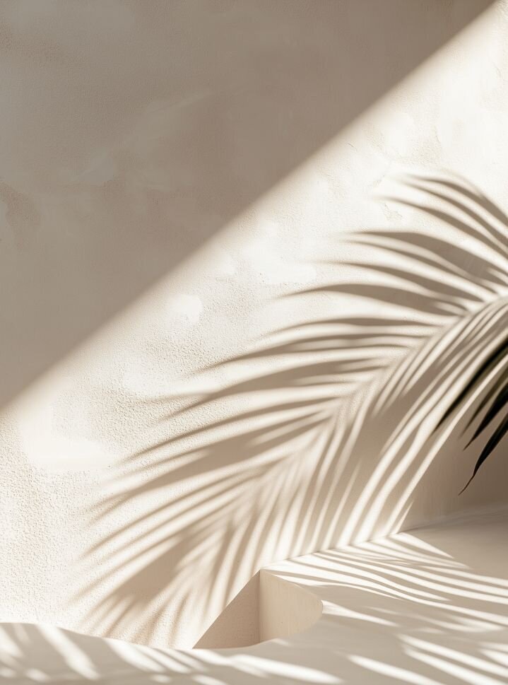 Soft palm leaf shadows on a beige wall, creating a calm and soothing background that reflects the peaceful, healing atmosphere of Relationship Experts.