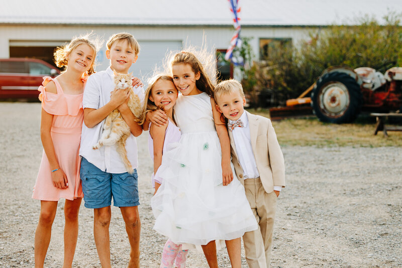 Kids holding farm cat at wedding in Choteau, MT