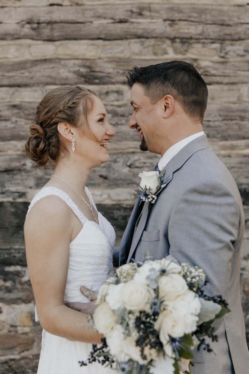 Liz and Eric on their wedding day smiling at each other