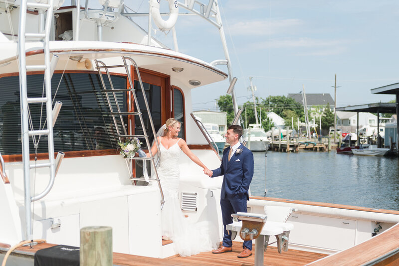 Bride leads groom up yacht stairs in Point Pleasant MarinaBride leads groom up yacht stairs in Point Pleasant Marina