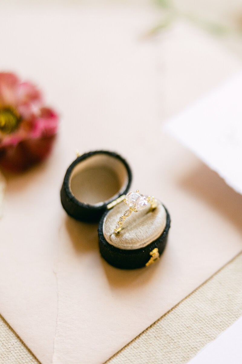 A beautifully styled flat lay of an engagement ring in a luxurious velvet ring box, captured at a wedding at the Mill House Hotel in Charleston, SC. A timeless detail highlighting the elegance of the celebration. Amia Marcell editorial photographer