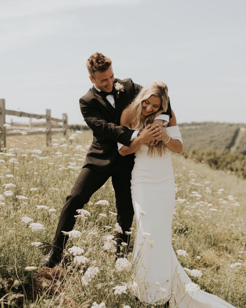 Bride and Groom in Field of Daisies - Victoria Costello Photography