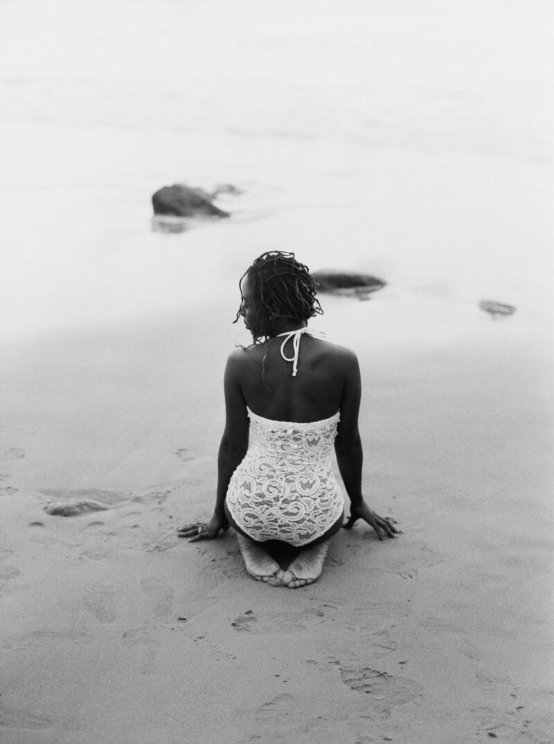 Woman sitting in the sand on a beach
