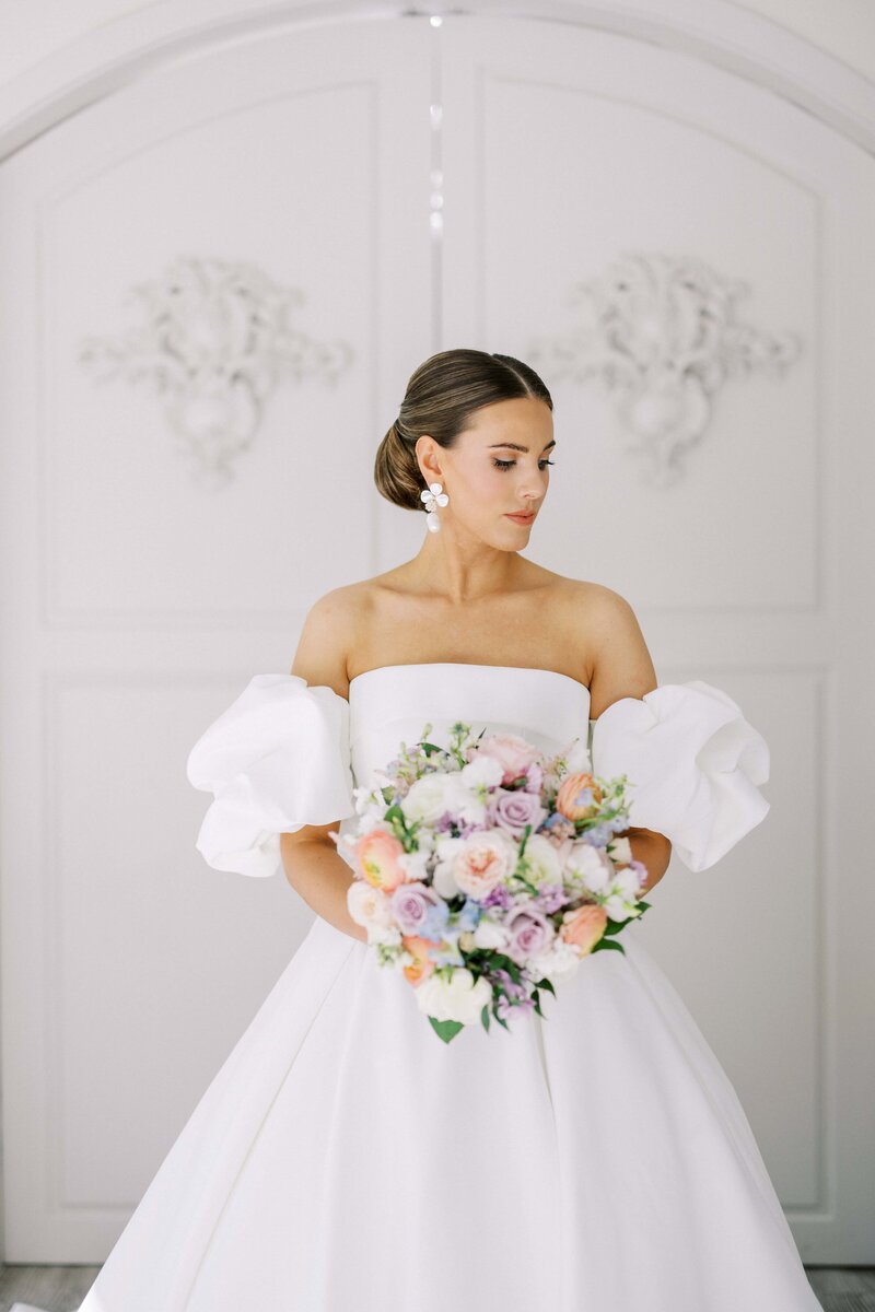 bride holding her bouquet inside the chapel