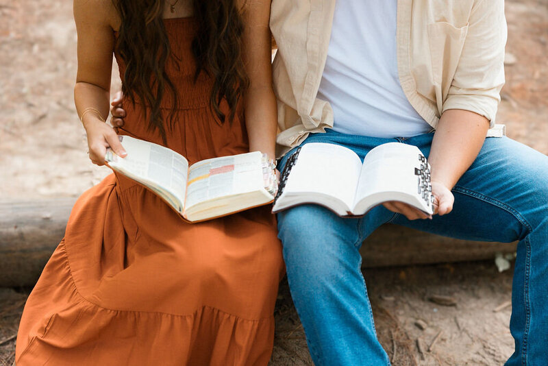 couple reads a book during engagement photoshoot