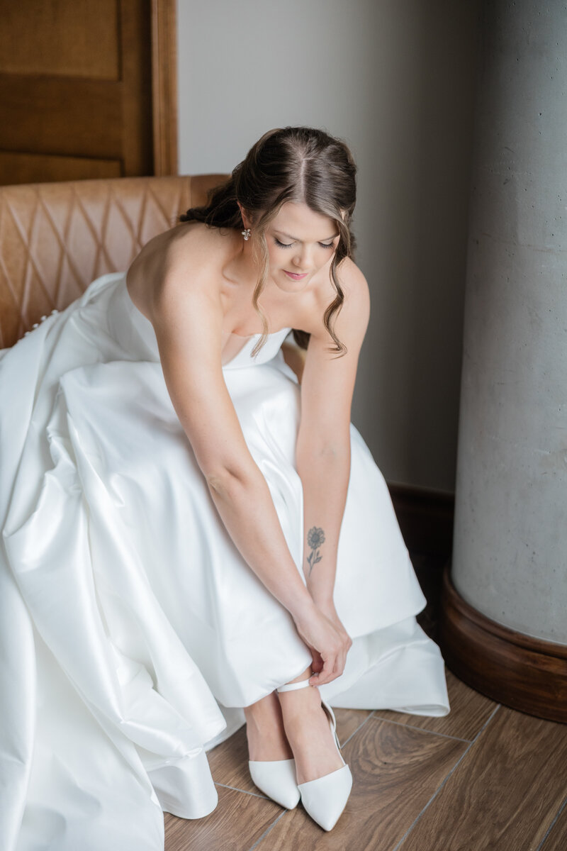 A Bride adjusting her shoe on her wedding day at the Ben in West Palm Beach. 