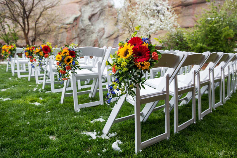 Chairs at Red Rocks set up for a wedding with florals