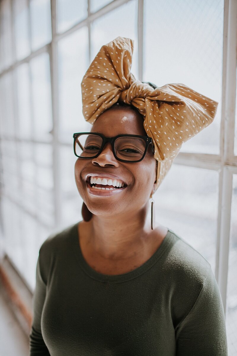 Yvette Henry laughing with headwrap.