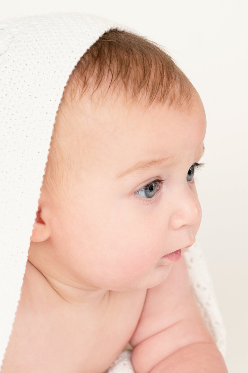 little boy with blanked over head, 9 months