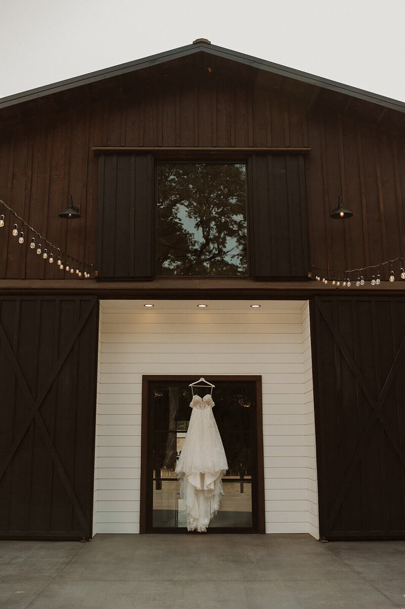 A beautiful wedding dress hung at Sage and Social during a Bubbly Bride Planning wedding 