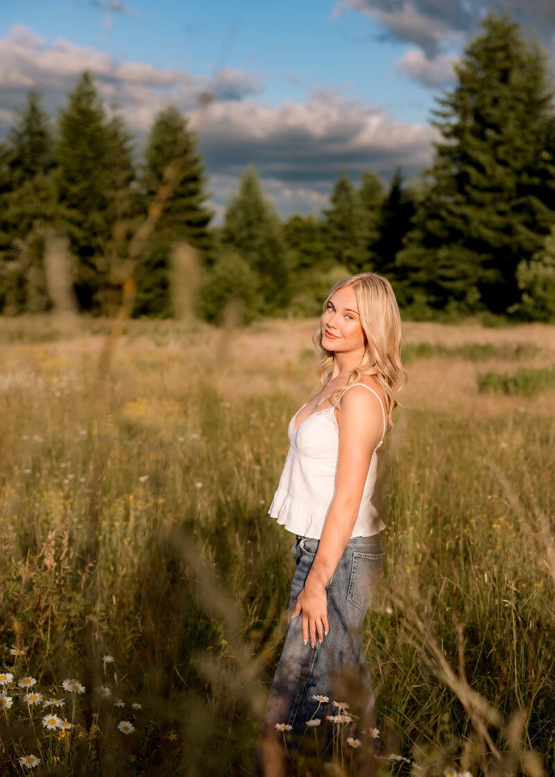Girl walking through a field during Golden Hour