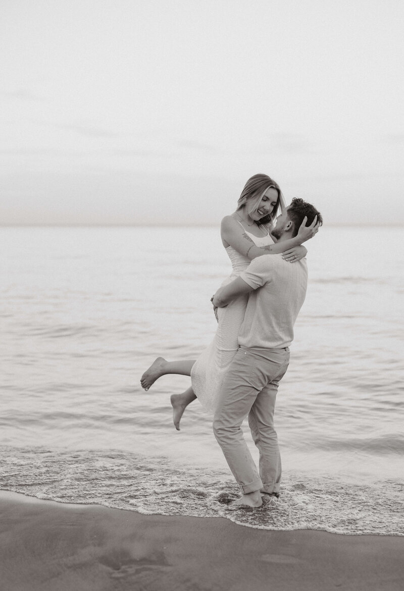 A couple embracing in a lift by the beach in Toronto.