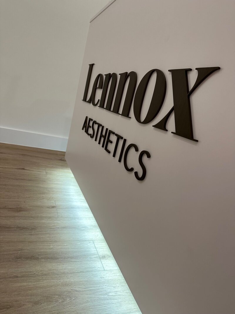 Lennox Aesthetics Logo On White Reception Desk 