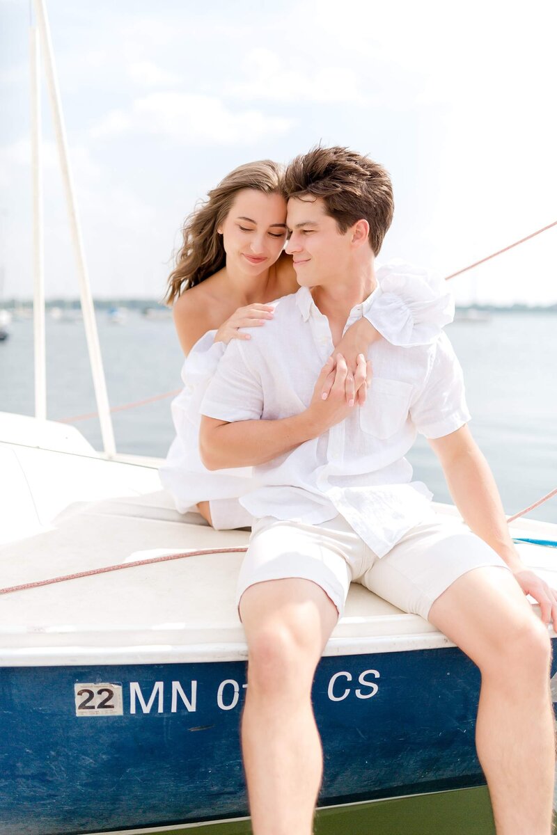 Engaged couple walk down a Stillwater, Minnesota street holding ice cream cones for engagement photo session.