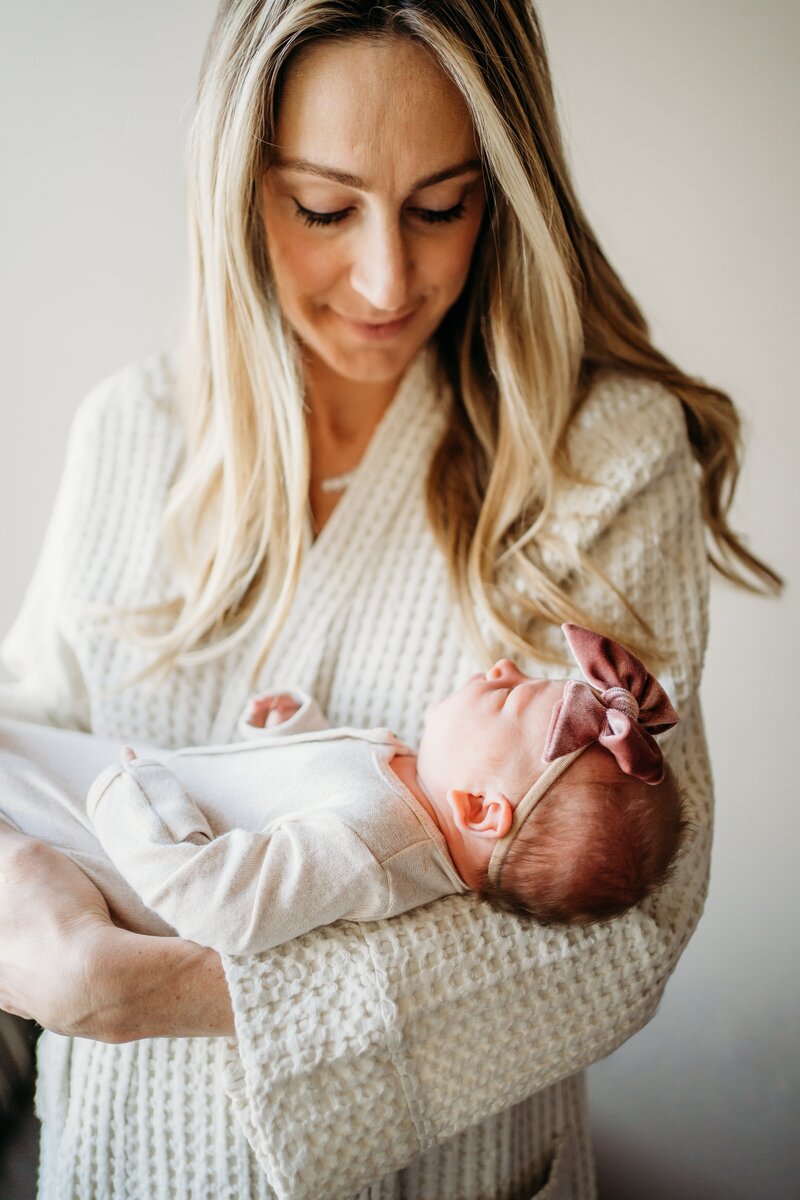 New mom holding her newborn in the hospital for fresh 48 photography