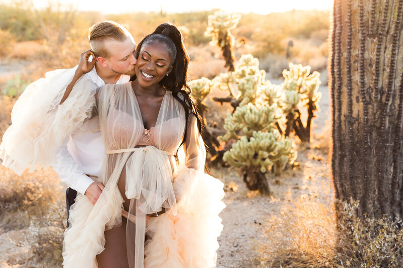 expecting parents embracing each other in Scottsdale desert maternity session