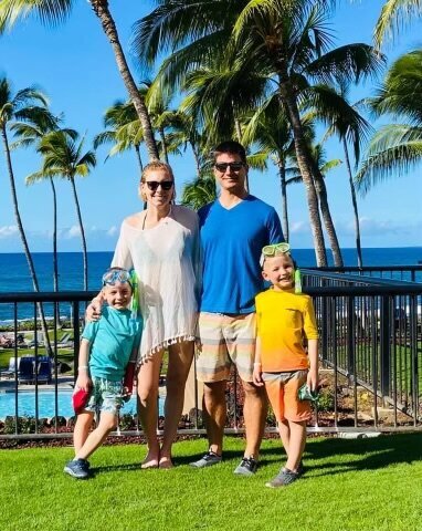 military family on vacation in hawaii next to beach