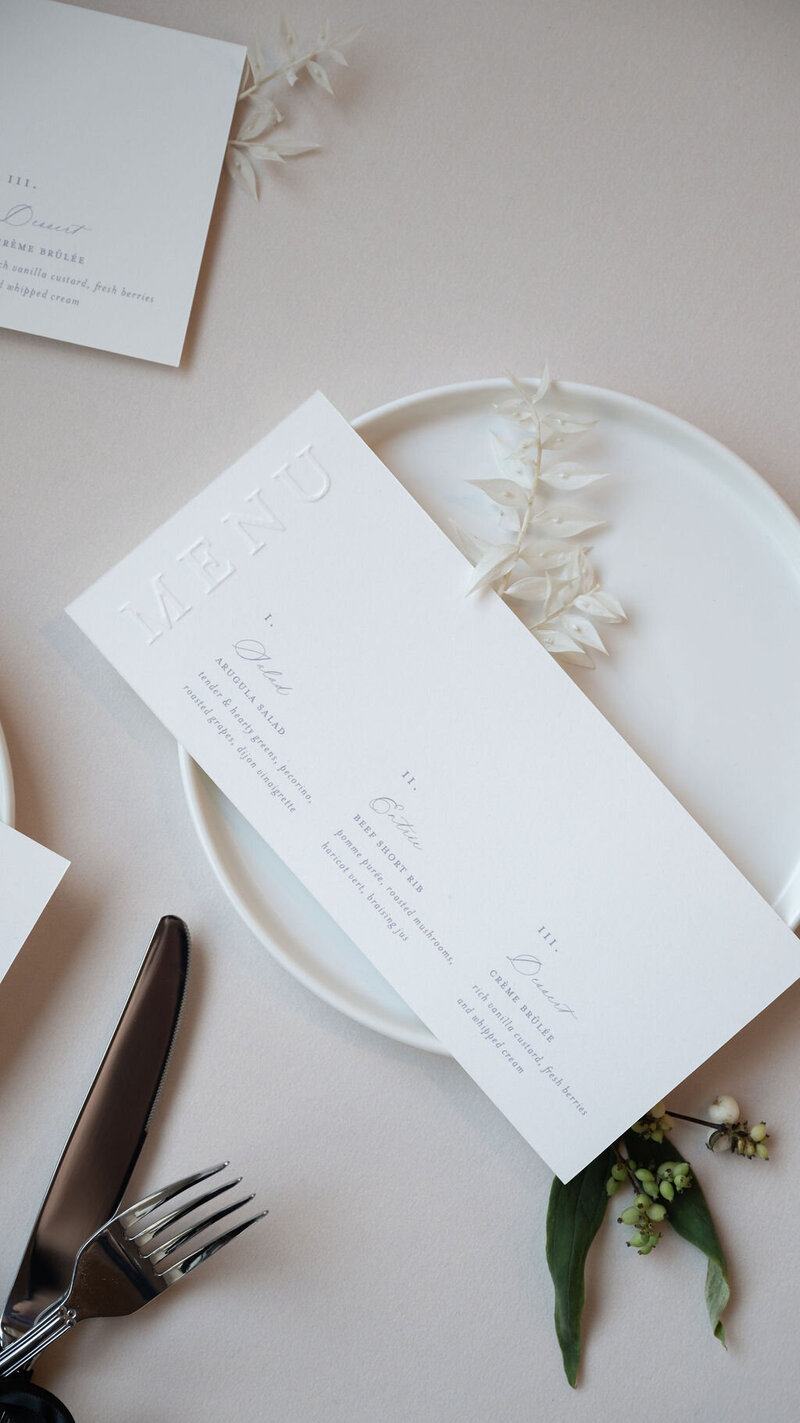 Sculpted blind emboss wedding menu in white