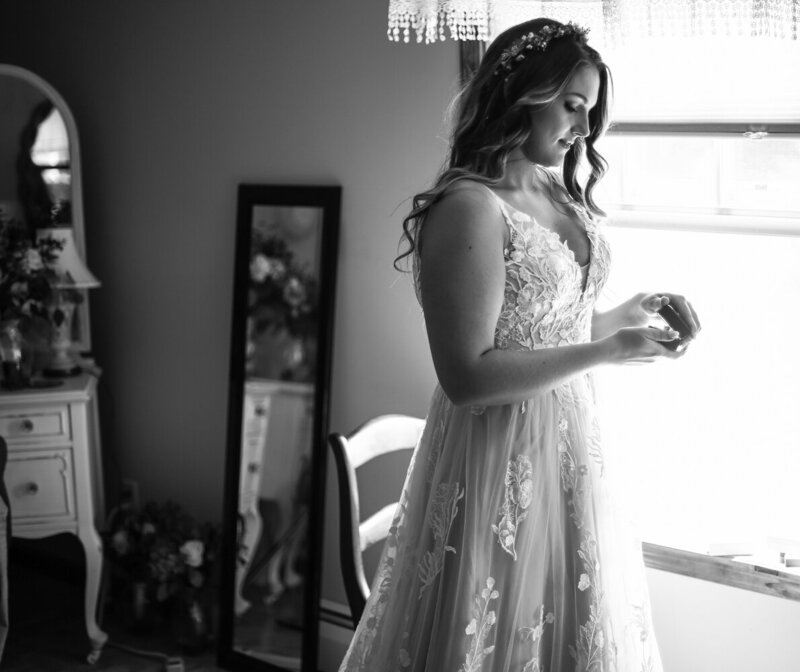 Solo portrait of bride getting ready before Whispering Trees Manor wedding