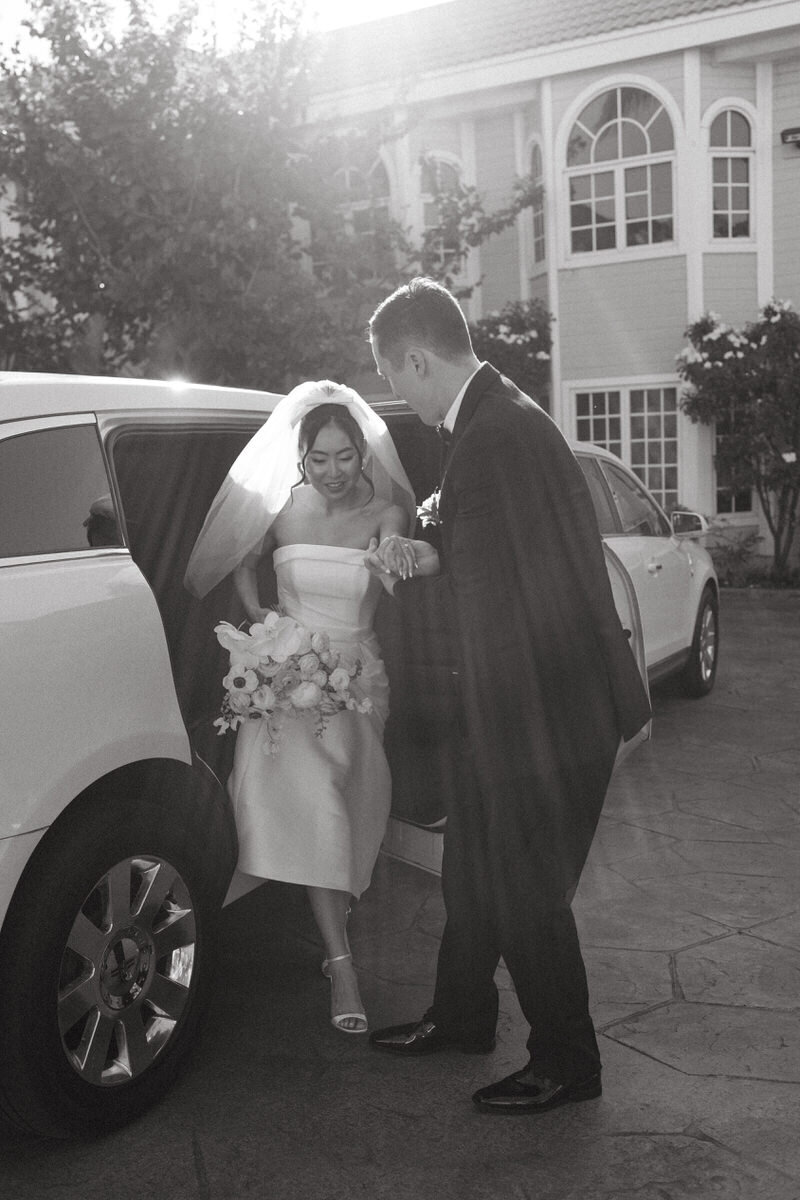 Bride and groom exit limo, captured by Oahu wedding photographer.