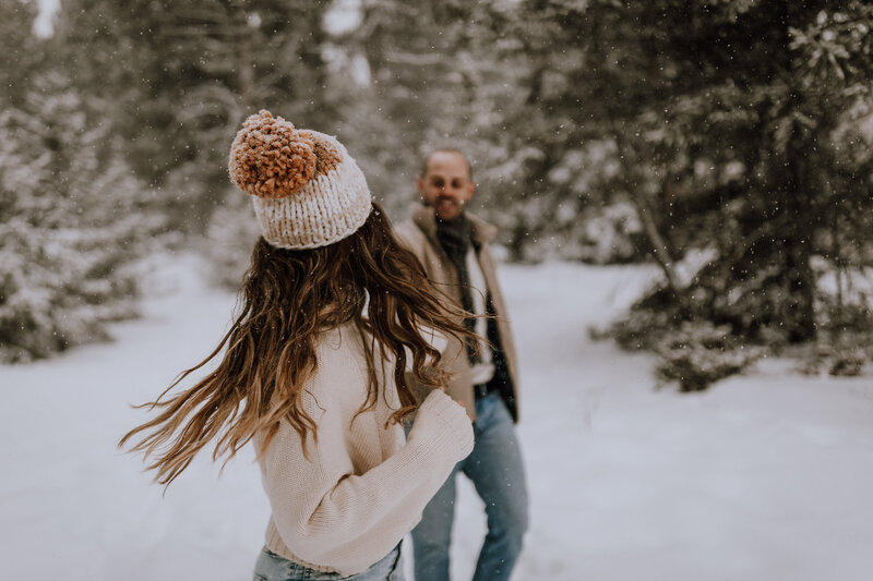 playful couple snowy session