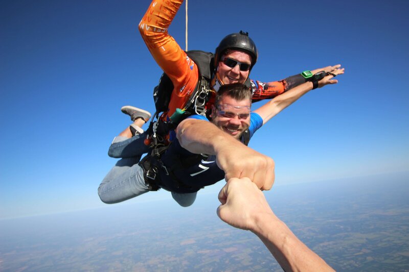 Julien Kibler fist bumping while skydiving
