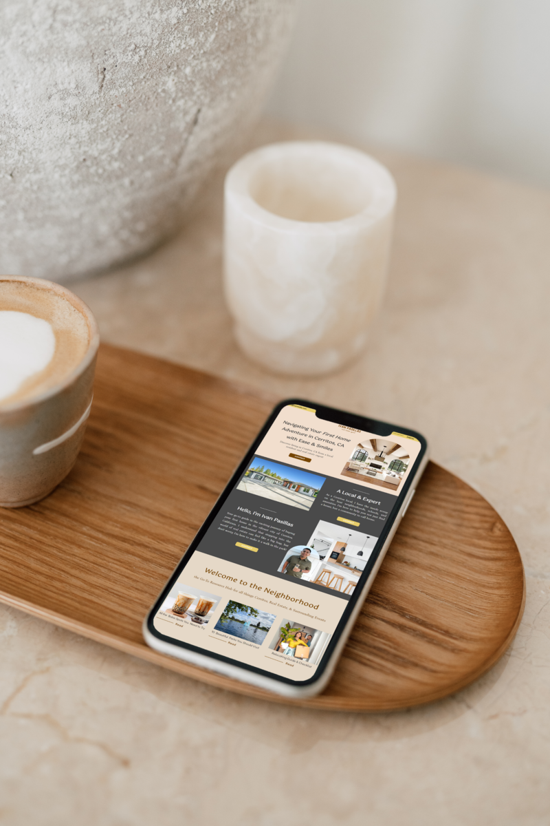 Mobile real estate agent website mockup on iPhone sitting on wooden tray