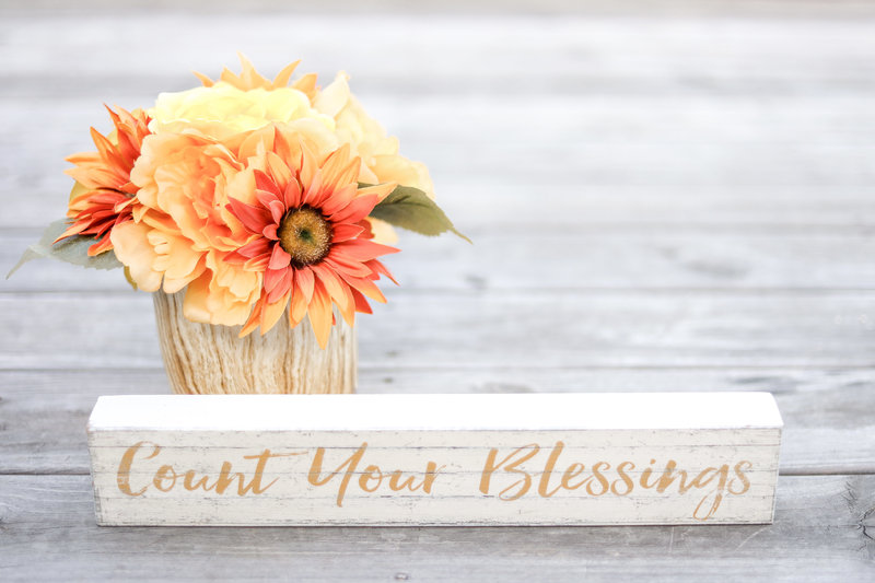 Count your blessings sign and flowers
