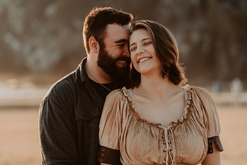 a couple embracing on an Oregon beach