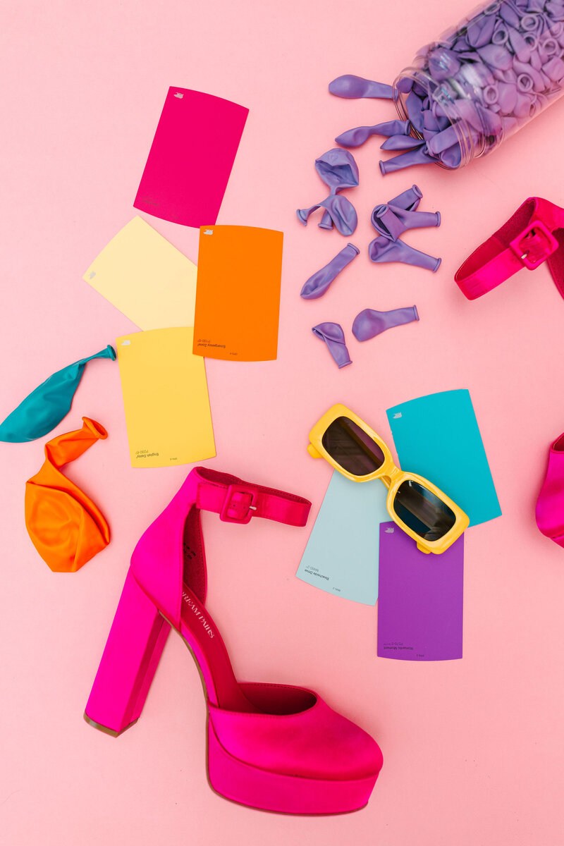 Raleigh Balloons, Event Decor and Rentals expert wearing a pink fun dress with Pantone color accents, showcasing creative balloon and décor services