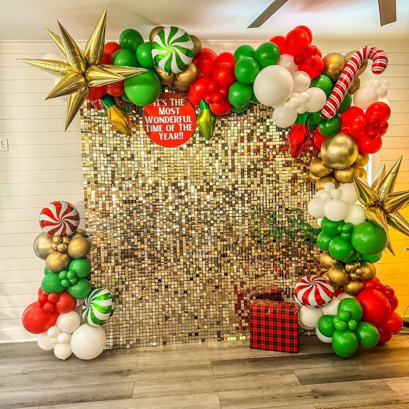gold shimmer wall with red, white, and green balloons for Christmas event